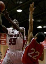 Palm Springs High School's Mike Brown shoots the ball as Whittier defenders try to block him Wednesday during their game in Palm Springs. The Indians won 59-52.